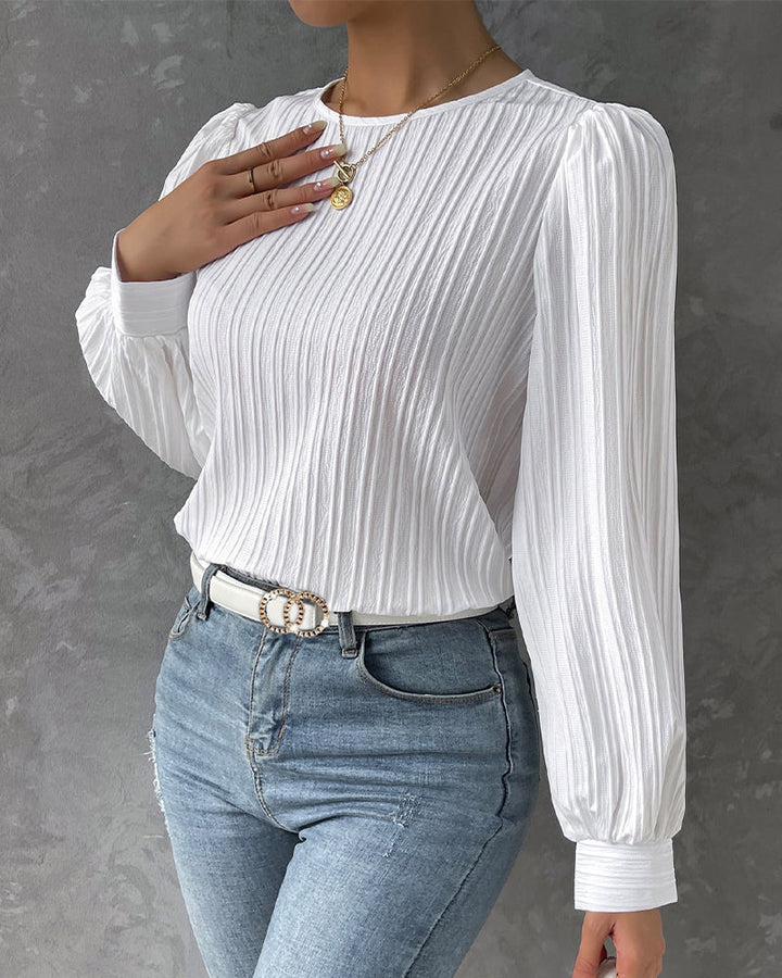 Timeless white women's long sleeve round neck shirt, offering comfort and versatile elegance.