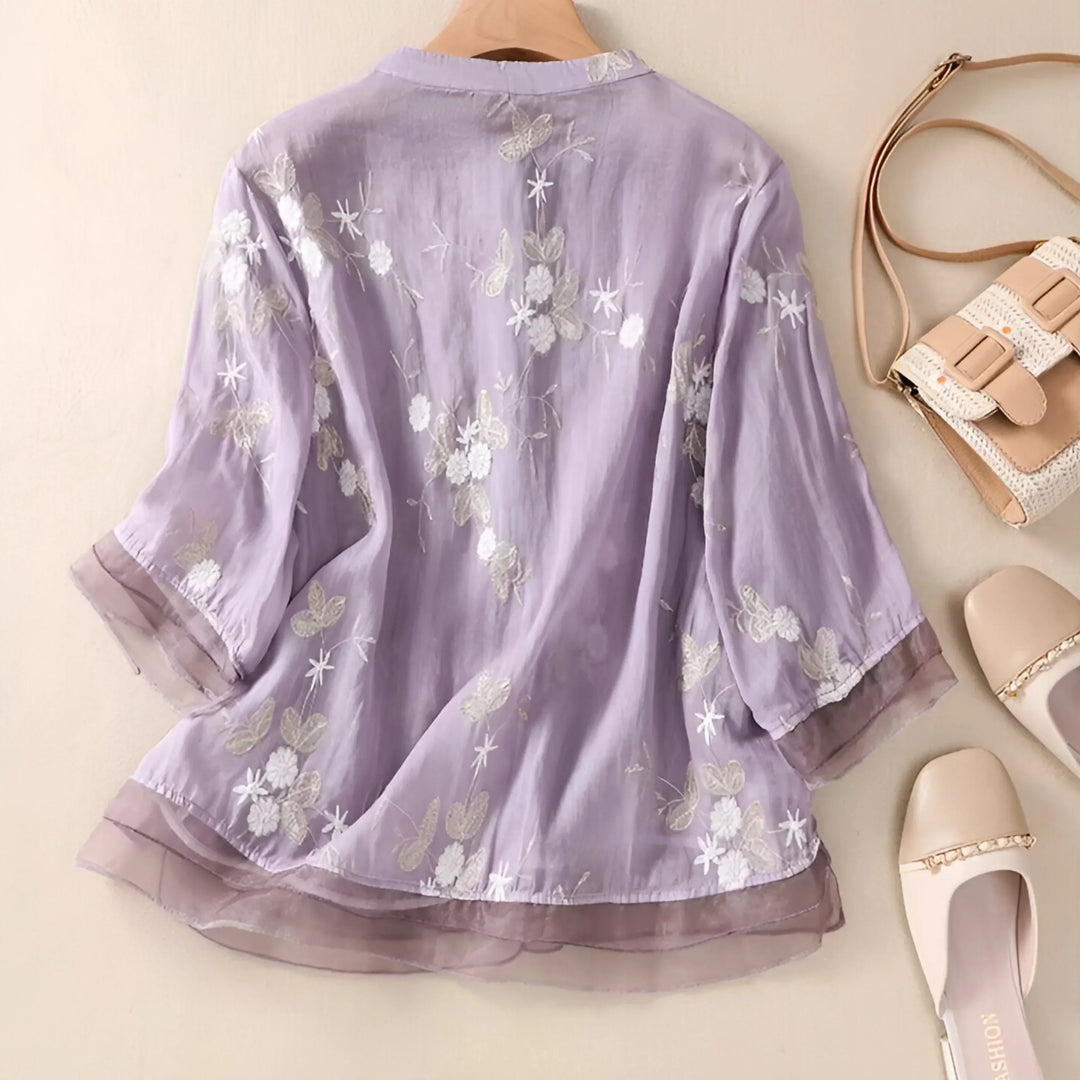 Versatile women's top featuring delicate floral embroidery and a relaxed, tummy skimming design.