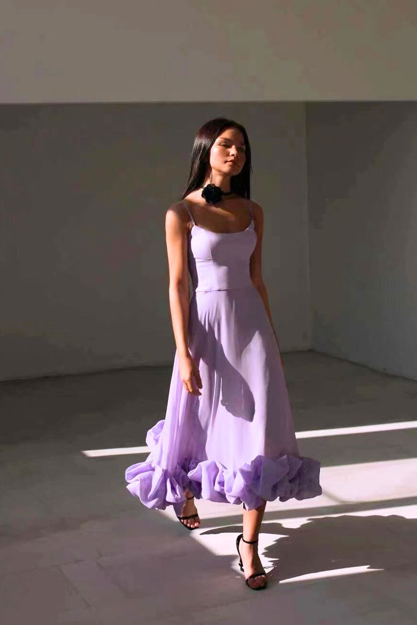 Chic women's flowing midi dress styled with accessories, versatile elegant wear for wedding guests & formal occasions.