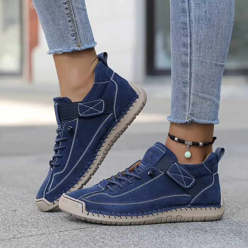 Side view of women's walking shoes, showcasing the supportive sole and casual footwear design.