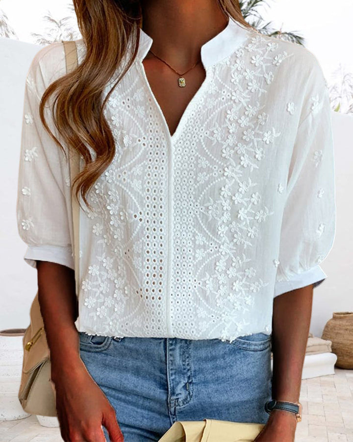Stylish women's white V-neck top with elegant puff sleeves, ideal for summer outfits.