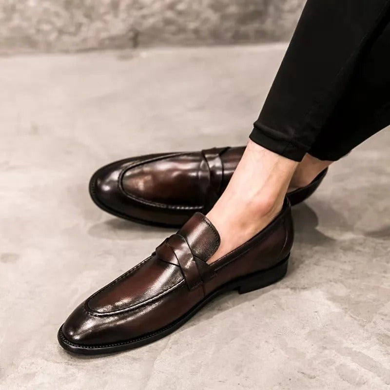 High-shine black leather men's slip-on penny loafers, a timeless & comfortable choice for dressy or casual looks.