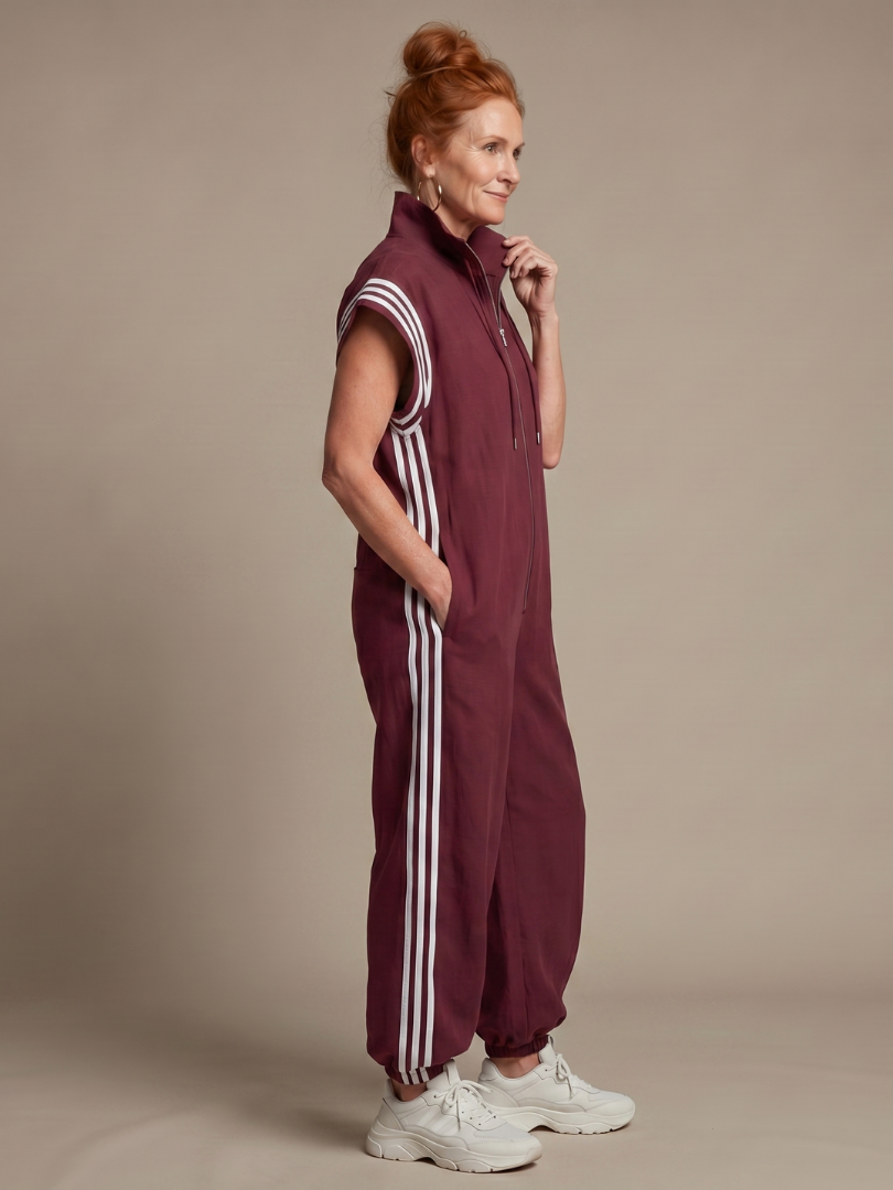 Stylish women's full-length jumpsuit with a modern zip front and chic stripe panel design.