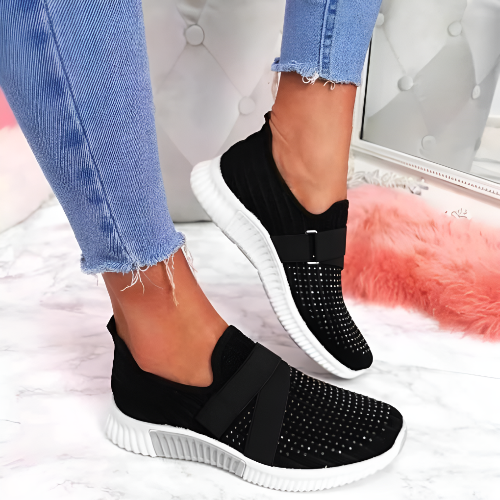 Lightweight women's slip-on sneakers with elastic strap. Breathable fabric and cushioned sole for ultimate comfort.