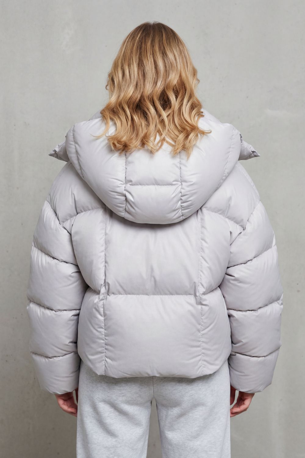 Stylish charcoal women's cropped puffer jacket, offering cloud-soft comfort for winter.