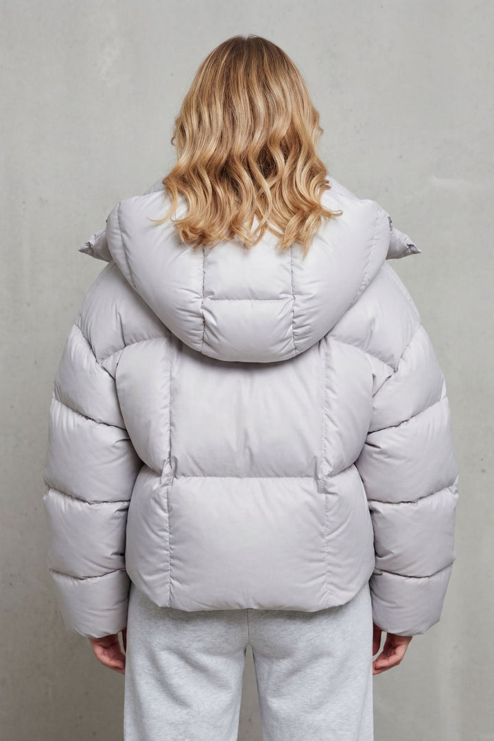 Stylish charcoal women's cropped puffer jacket, offering cloud-soft comfort for winter.