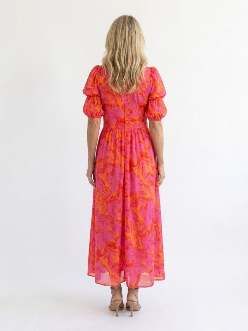 Vibrant pink floral midi dress for women featuring a stylish V-neck and trendy puff sleeves. Summer fashion essential.