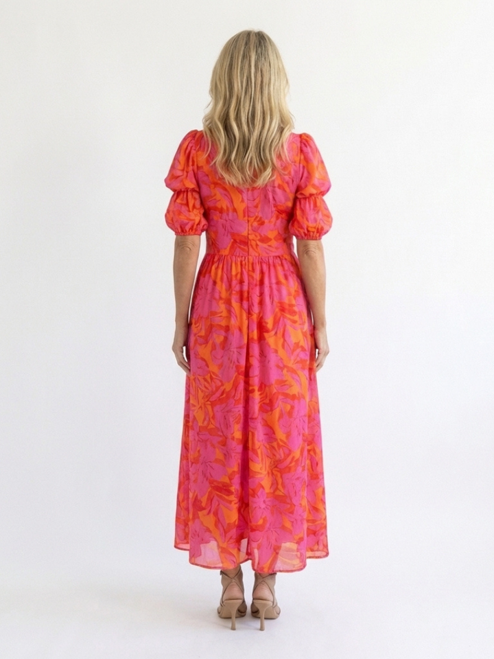 Vibrant pink floral midi dress for women featuring a stylish V-neck and trendy puff sleeves. Summer fashion essential.