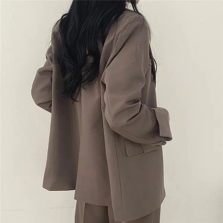Smart women's office suit, featuring a modern blazer and perfectly cut trousers.