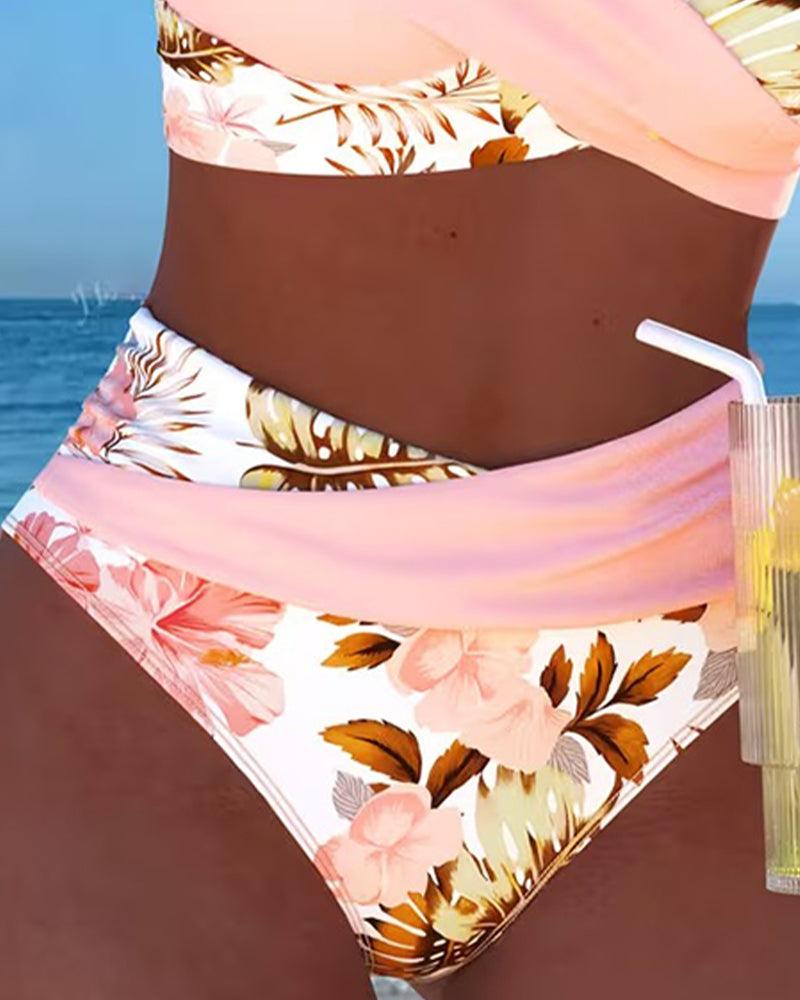 Trendy women's high-waisted bikini with vibrant floral print and chic cut-out details, ideal for vacation.