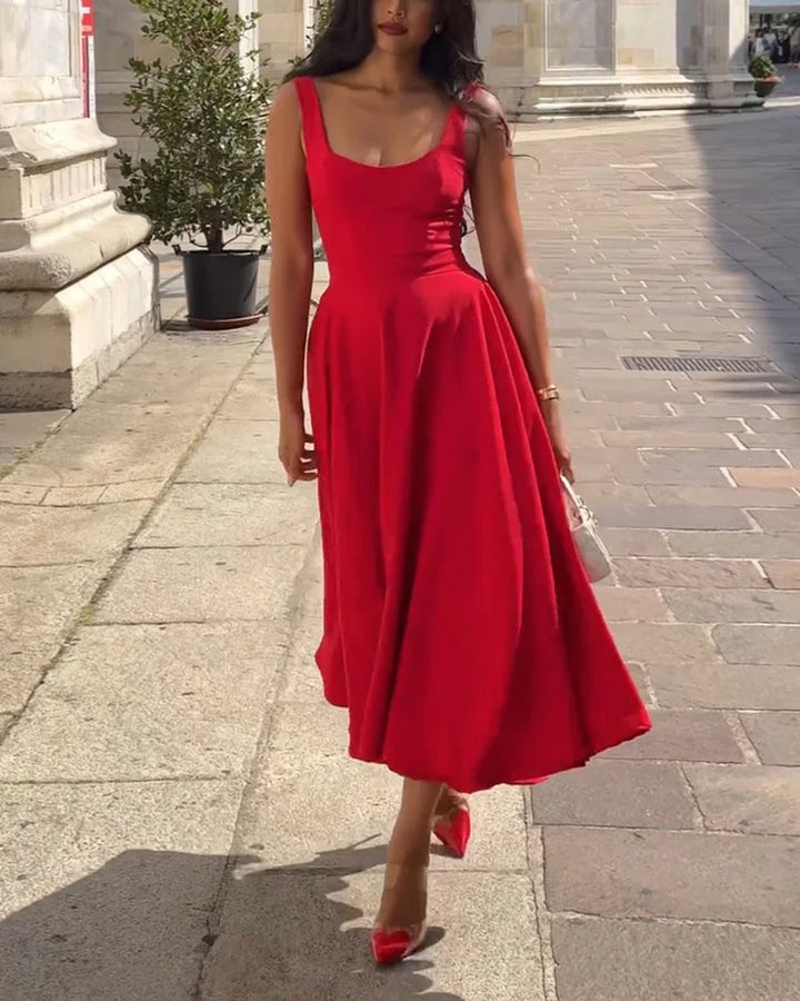Elegant women's red fitted midi dress with thin straps, perfect for evening or summer casual chic.