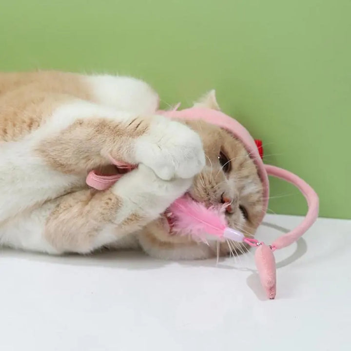 Playful cat hat with a dangling toy, an interactive pet accessory for endless fun.