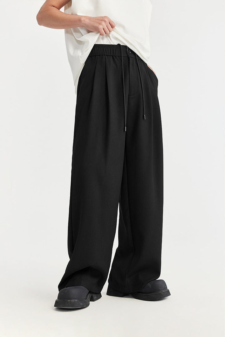Comfortable men's wide leg pants with a relaxed fit and drawstring waist for modern casual wear.