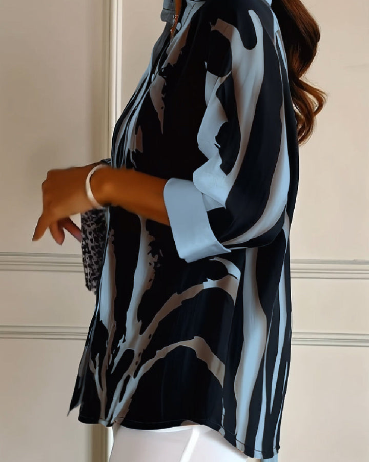 Casual chic women's irregular printed blouse, stand collar, long raglan sleeves & subtle button detail.