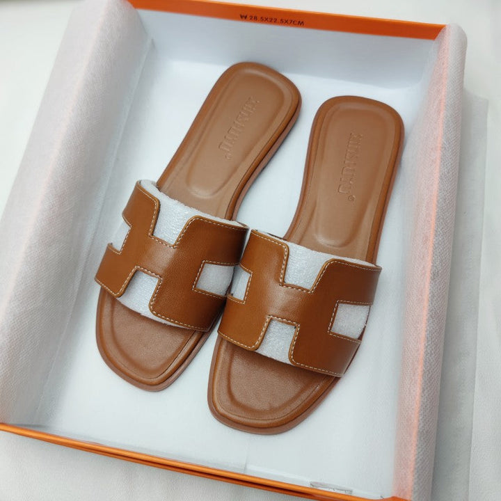Stylish women's H-strap slip-on sandals, versatile for summer dress or casual outfits, with a low heel.