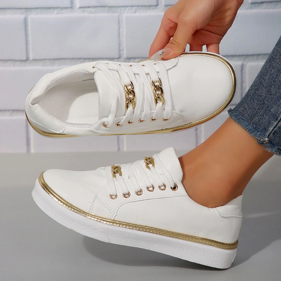 Women's comfortable white sneakers with elegant gold accents, perfect for versatile everyday casual wear.
