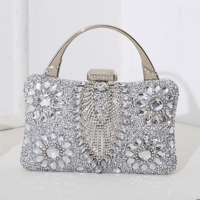 Women's metallic silver-tone clutch with geometric diamond inlay. Essential glamorous evening accessory.