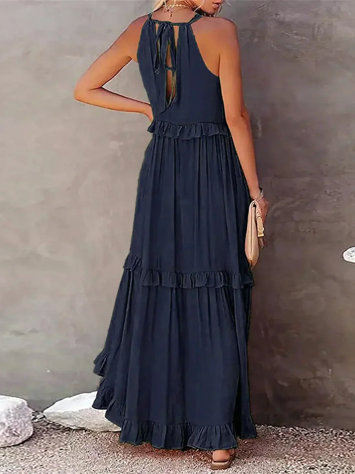 Casual summer women's dress: halterneck, ruffles, maxi length & handy pockets.