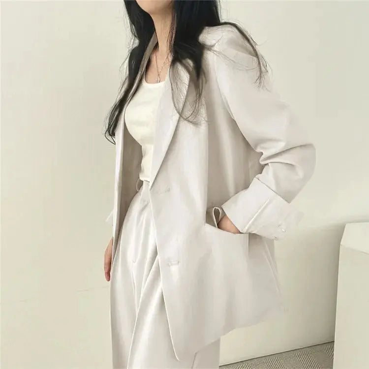 Sophisticated women's suit, two-piece blazer & trousers for a polished look.