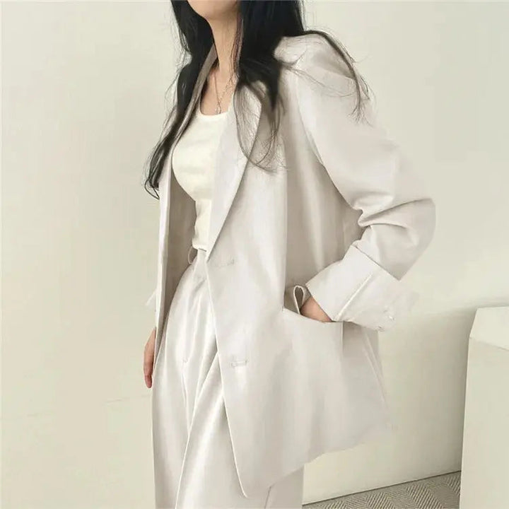 Sophisticated women's suit, two-piece blazer & trousers for a polished look.