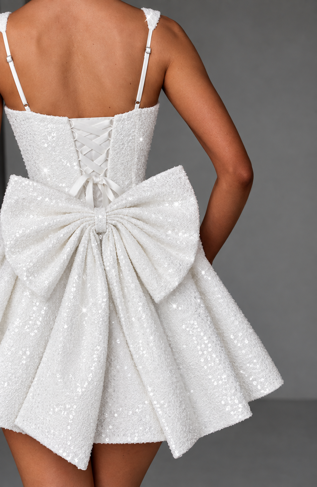 Party-ready women's mini dress, flared style, elegant bow detail, suitable for special evenings.