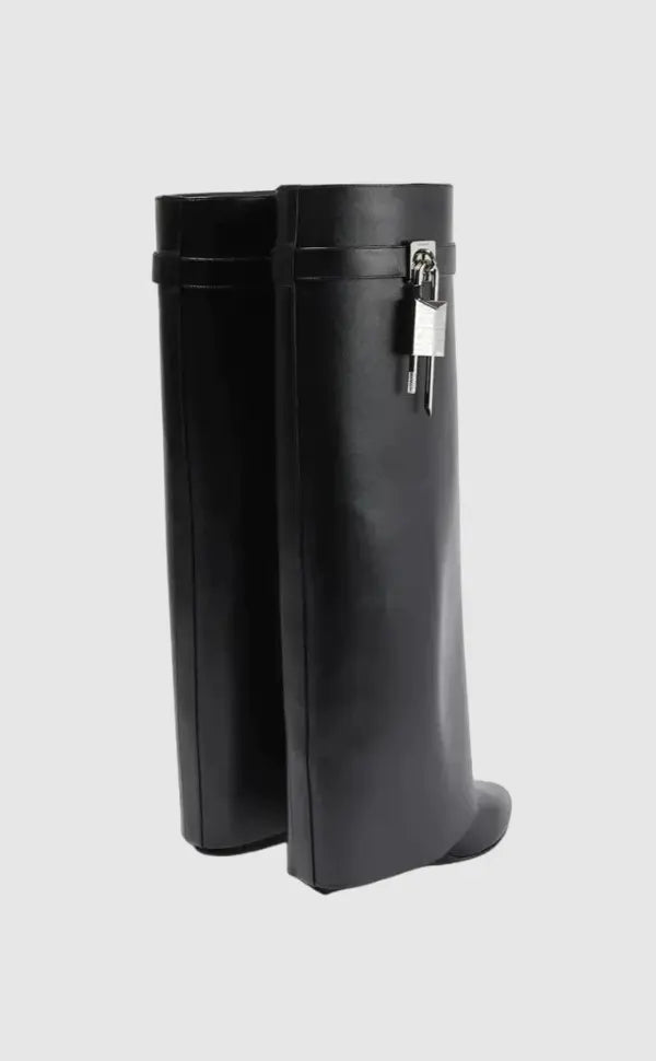 Glossy black women's knee-high boots with an eye-catching sculptural wedge for street style.