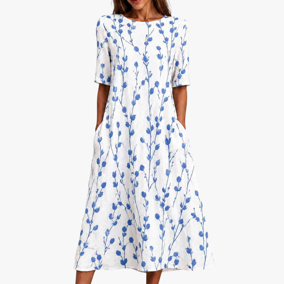 Women's blue floral midi dress with pockets. Effortlessly stylish & comfortable, perfect for spring/summer casual wear.