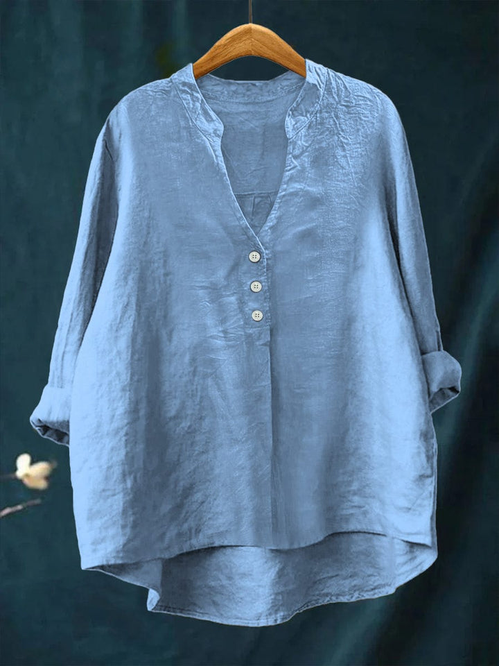 Chic women's button-front top for everyday wear. Relaxed fit blouse with a high-low hem, perfect for versatile summer style.