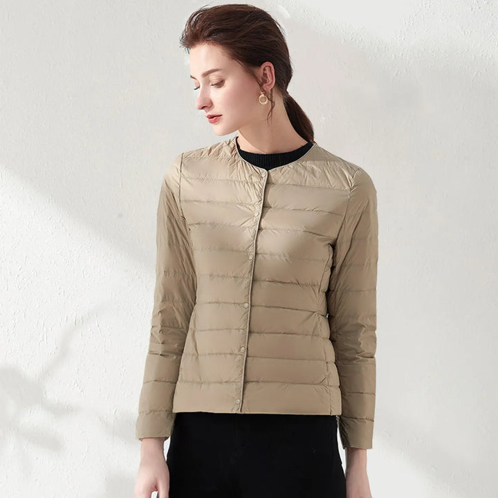 Stylish women's collarless puffer jacket. A sleek, slimming silhouette for casual and everyday wear.