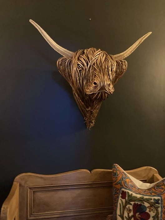Detailed view of a rustic rattan Toro wall sculpture, handmade natural texture for living room decor.