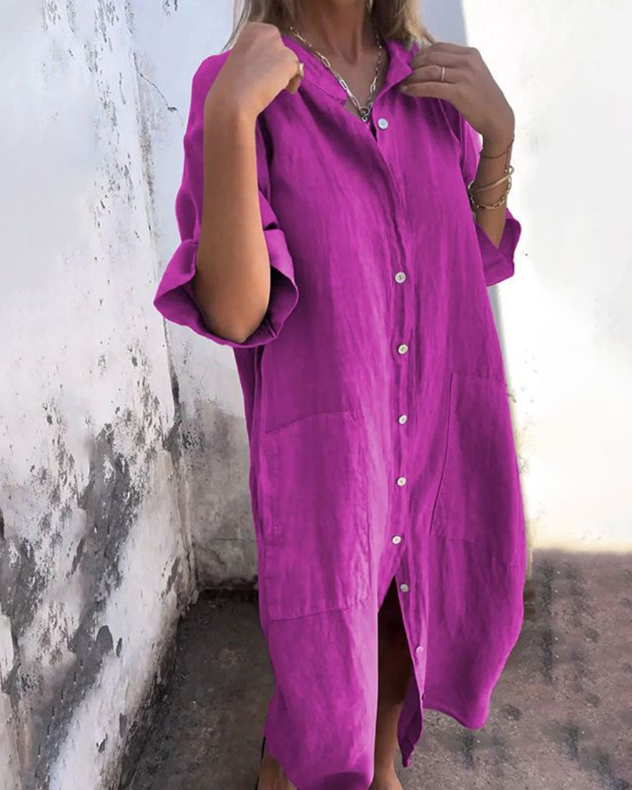 Side profile of a women's casual shirt dress with short sleeves, showcasing its flattering relaxed fit.