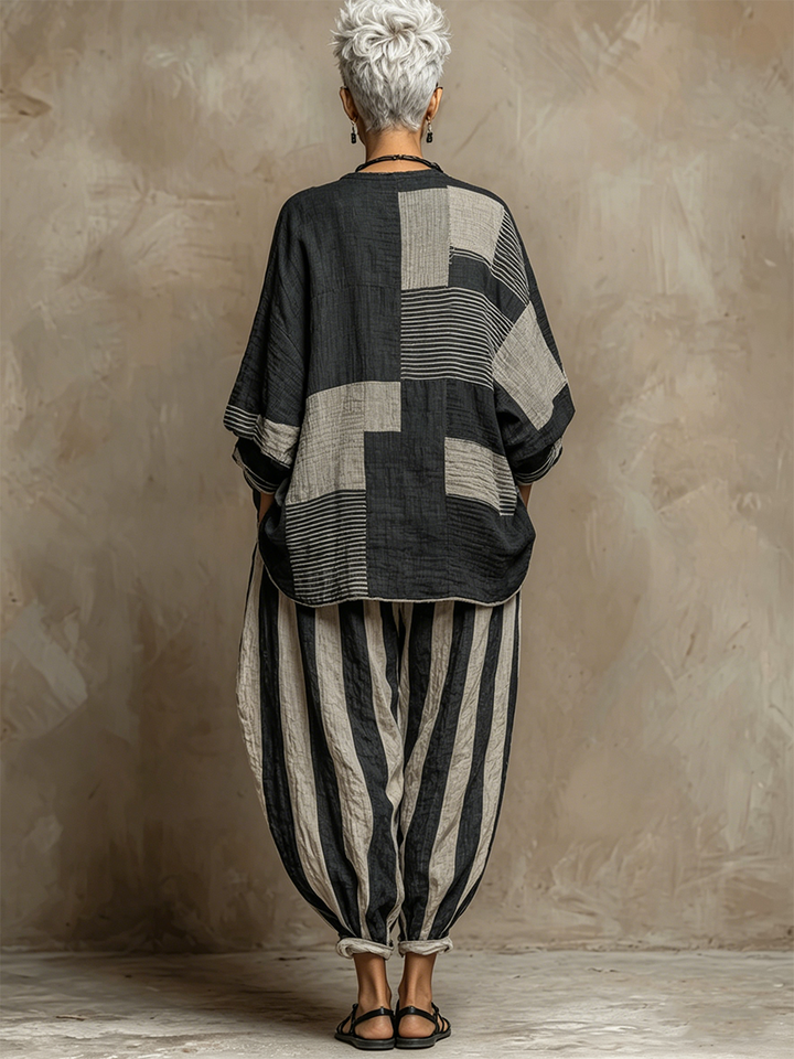 Comfortable women's two-piece loungewear set with a stylish colour-block top and striped wide-leg trousers.
