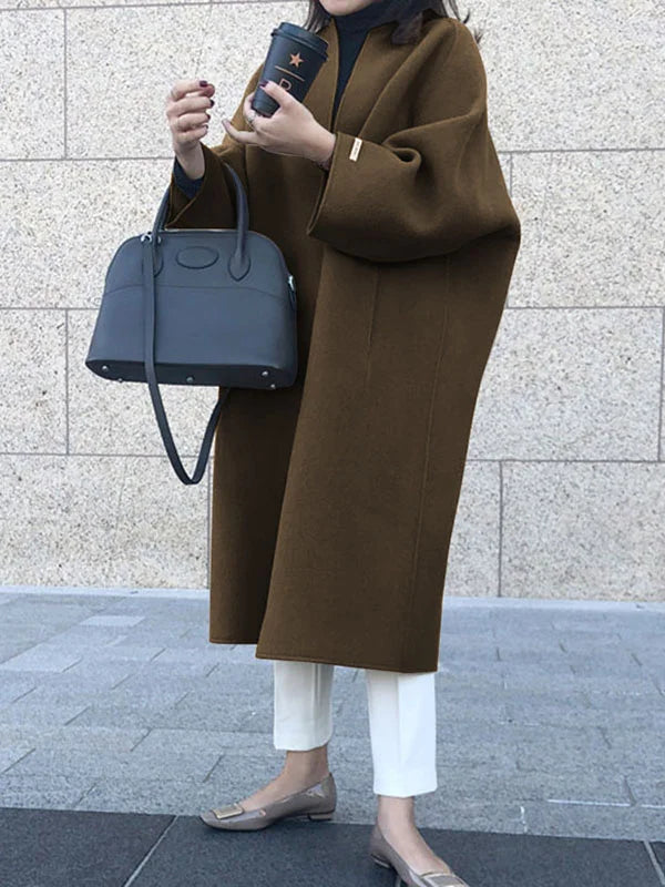 Chic brown long coat for women, a versatile piece of winter outerwear providing warmth & style.