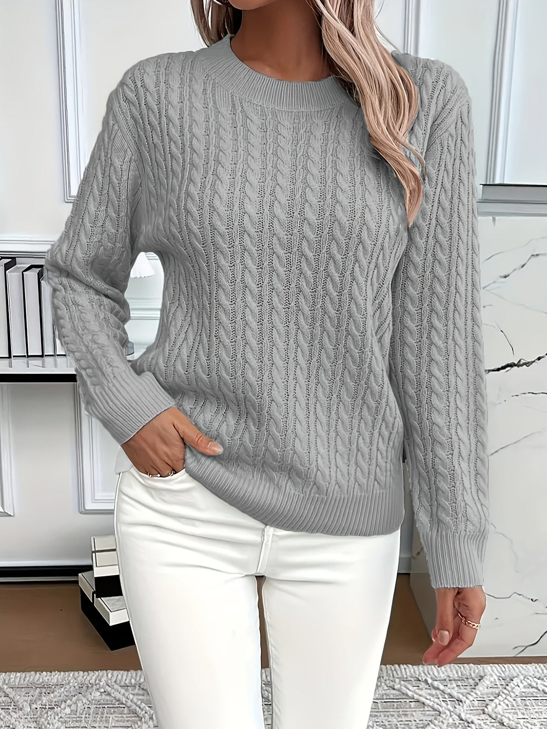 Intricate cable knit women's jumper. Cozy knitted top, a classic style pullover for cold weather.