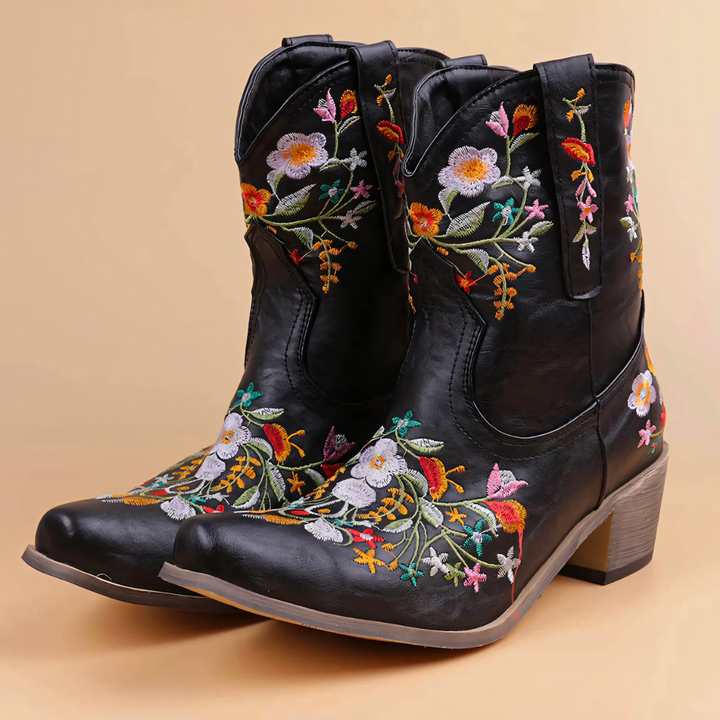 Close-up of stylish women's western boots featuring detailed vintage embroidery on weatherproof leather.