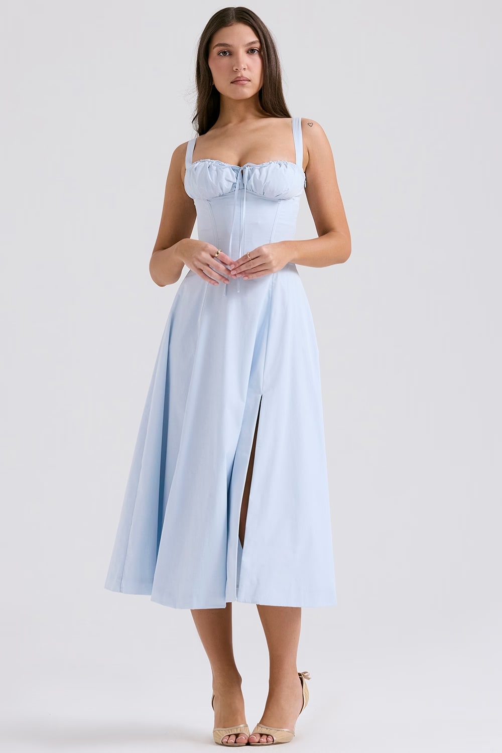 Side profile of a sophisticated blue lace-up corset midi dress. Ideal women's party wear.