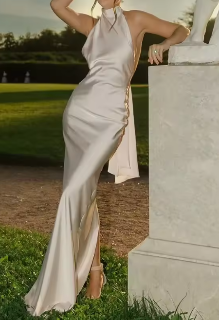 Sophisticated white cowl neck maxi dress for women. Elegant sleeveless evening gown, perfect for special occasions.