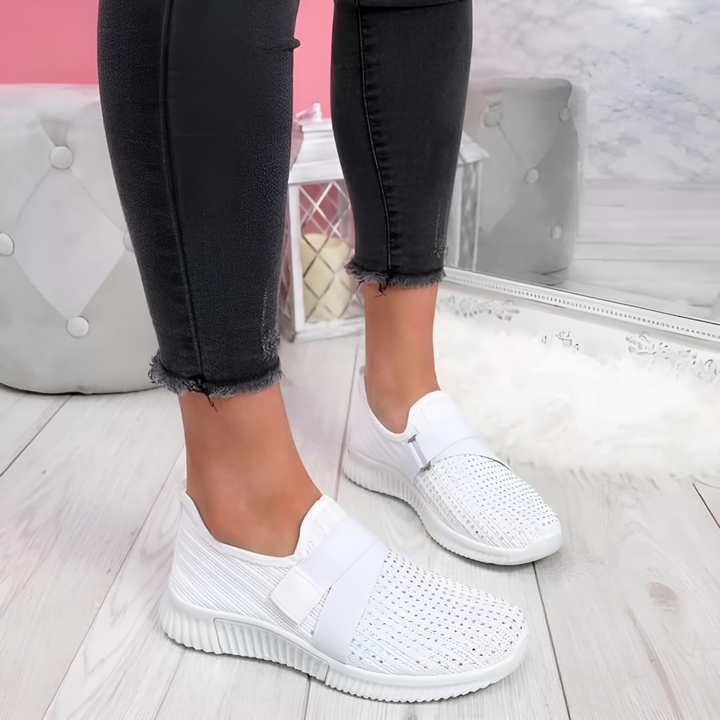 Close-up of elastic strap on women's slip-on trainers. Easy-wear athletic sneakers designed for comfort and style.