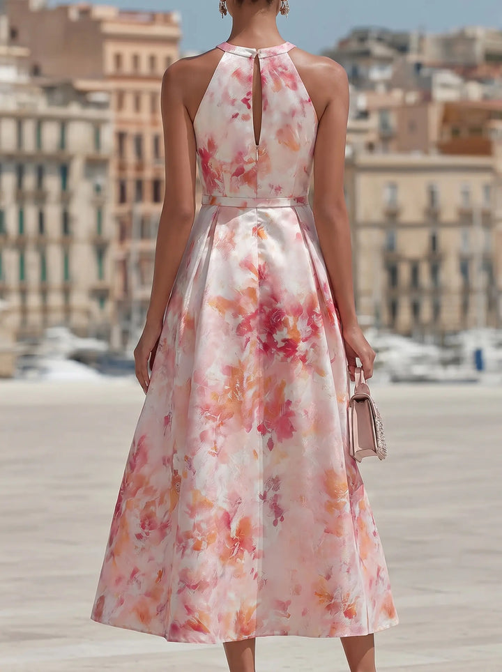 Pink watercolor floral midi dress for women, featuring a chic halter neckline and flowy, elegant design. Summer ready.