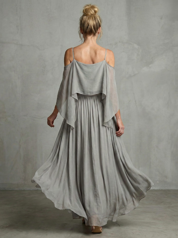 Close-up of women's grey layered drape cold shoulder top & flowy wide leg pants set. Perfect for casual wear.
