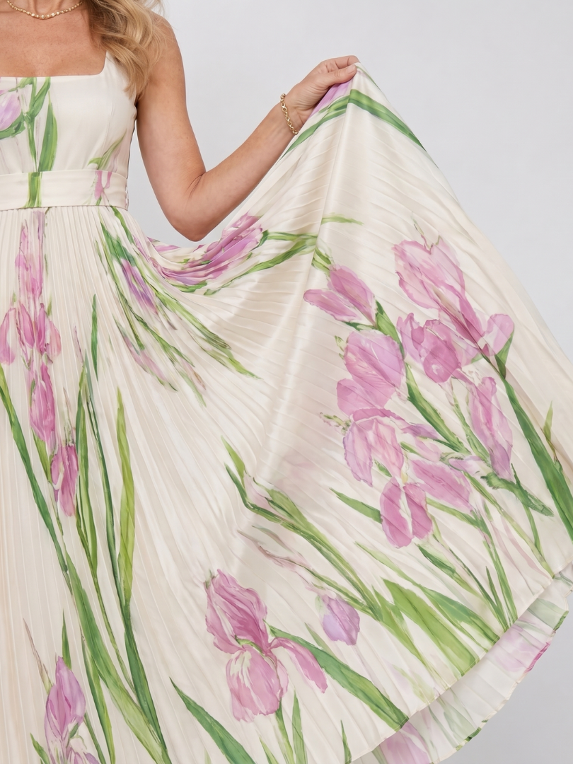 Close-up of the unique square neckline on a women's pleated sleeveless midi dress. Elegant style.