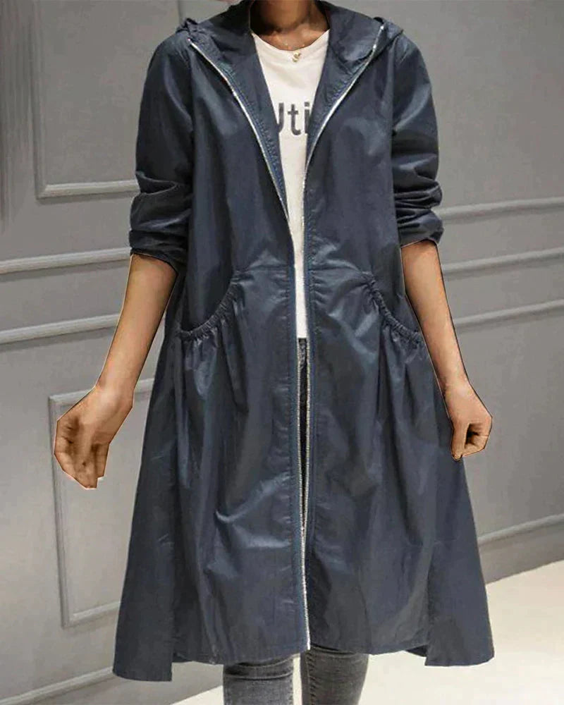 Versatile knee-length waterproof coat for women, an elegant long rain jacket for all-weather style.