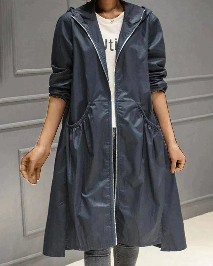 Versatile knee-length waterproof coat for women, an elegant long rain jacket for all-weather style.