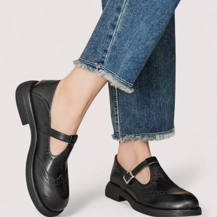 Women's classic Mary Jane shoes in black with brogue detailing, ideal for elegant and vintage-style wear.