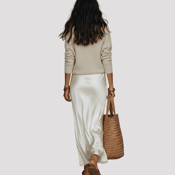 Detailed view of a women's elegant V-neck layered maxi dress. Soft fabric, long sleeves for modern comfort.