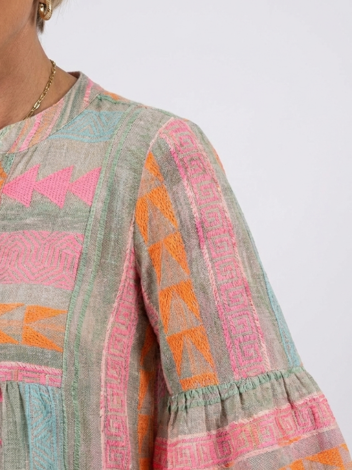 Stylish women's pink geometric print dress, V-neck, tiered knee-length with three-quarter sleeves for summer.