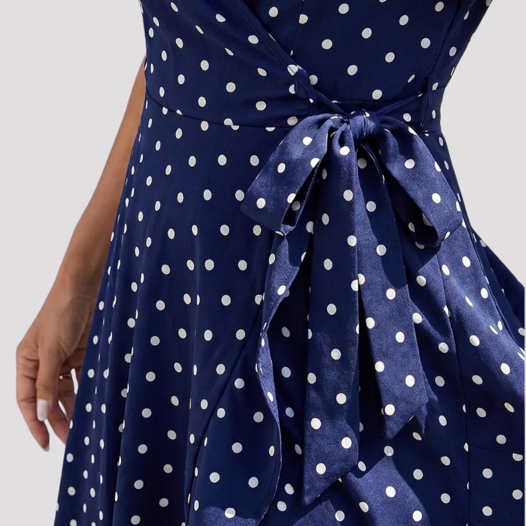 Elegant women's polka dot midi wrap dress with a V-neck and short flutter sleeves, a versatile summer day dress.