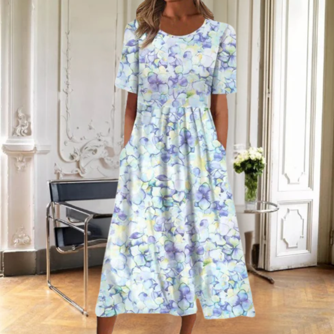 Elegant patterned women's midi dress with a colorful floral design, short sleeves, and a simple round neckline.