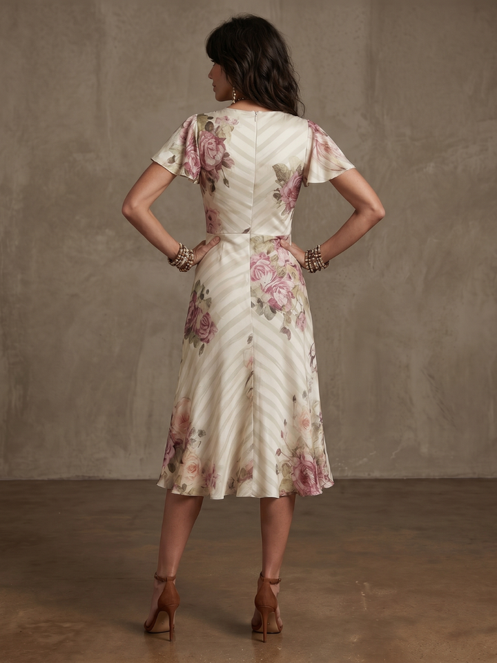 Stylish women's floral wrap midi dress with ruched accents, offering an elegant and versatile look.