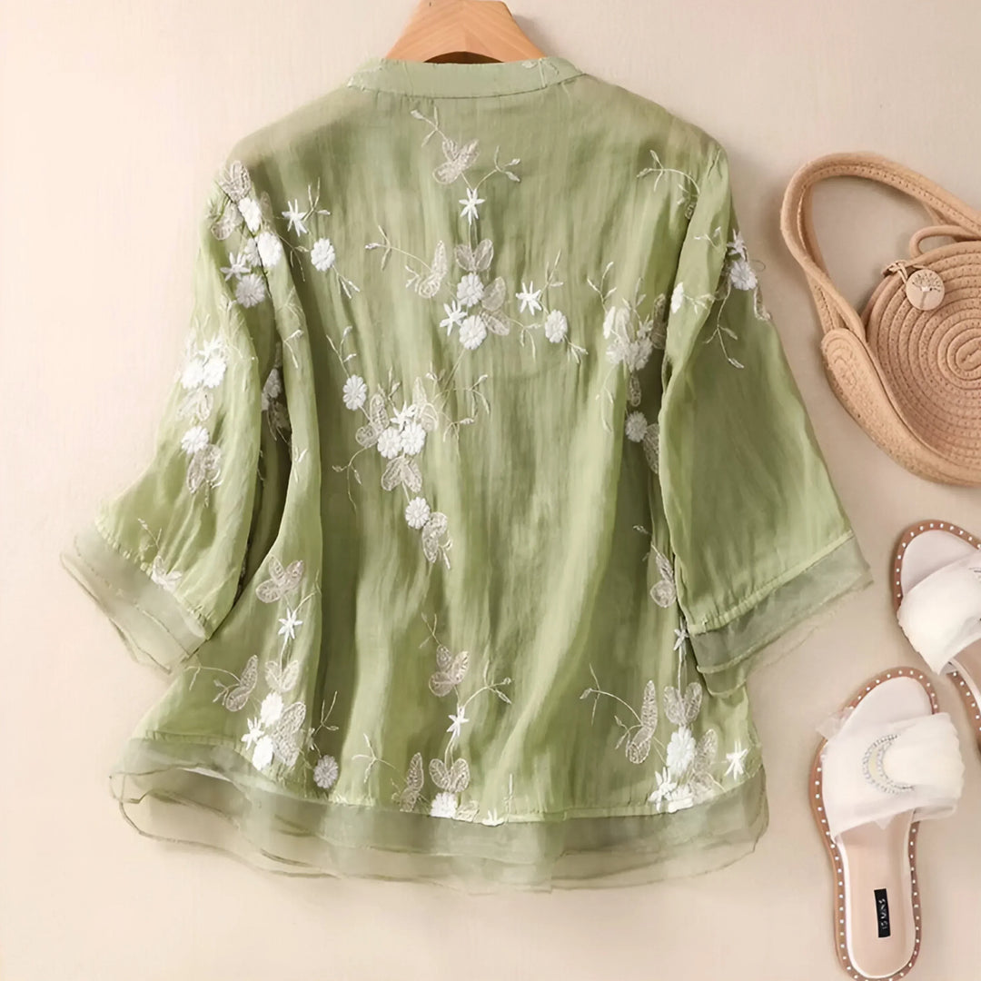 Chic embroidered women's top. Floral design, elegant style, and a flattering tummy skimming fit.
